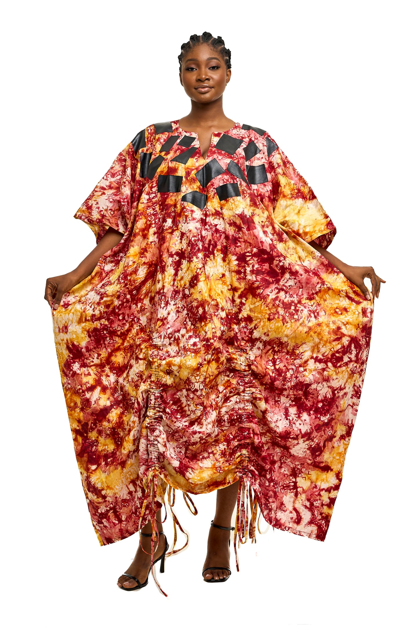 Woman wearing a colorful patterned dress with a white background
