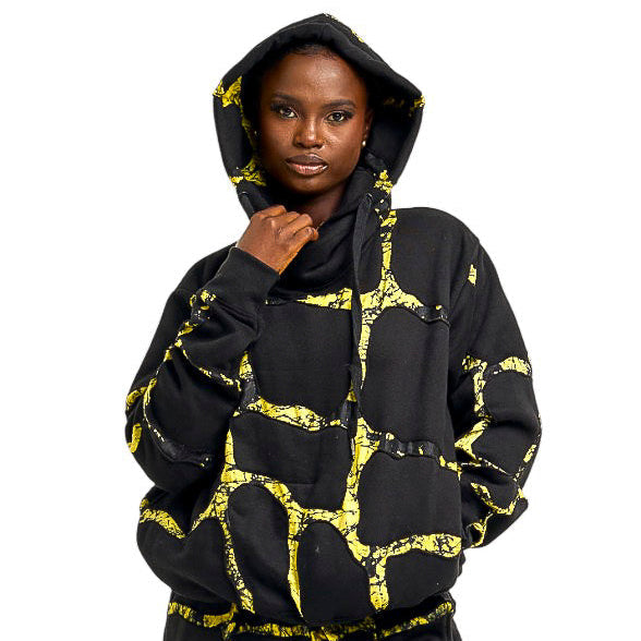 Person wearing a black and yellow patterned outfit on a white background
