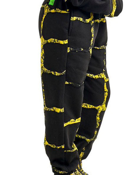 Person wearing a black and yellow patterned outfit on a white background