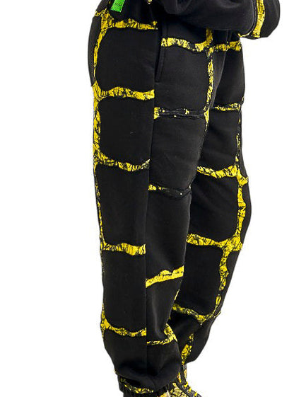 Person wearing a black and yellow patterned outfit on a white background