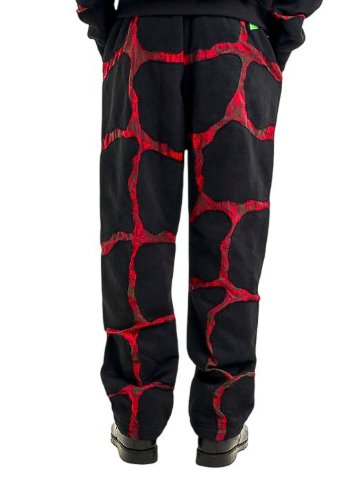 Black and red patterned sweatpants set on a white background