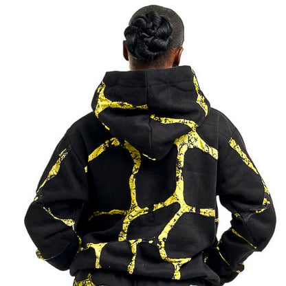 Person wearing a black and yellow patterned outfit on a white background