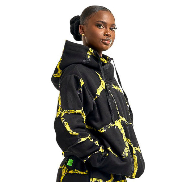 Person wearing a black and yellow patterned outfit on a white background