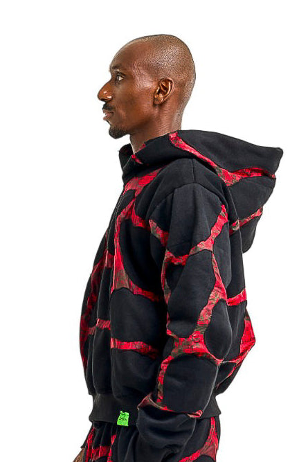 African man wearing black and red hoodie, made with adire traditional fabric. Made in Nigeria